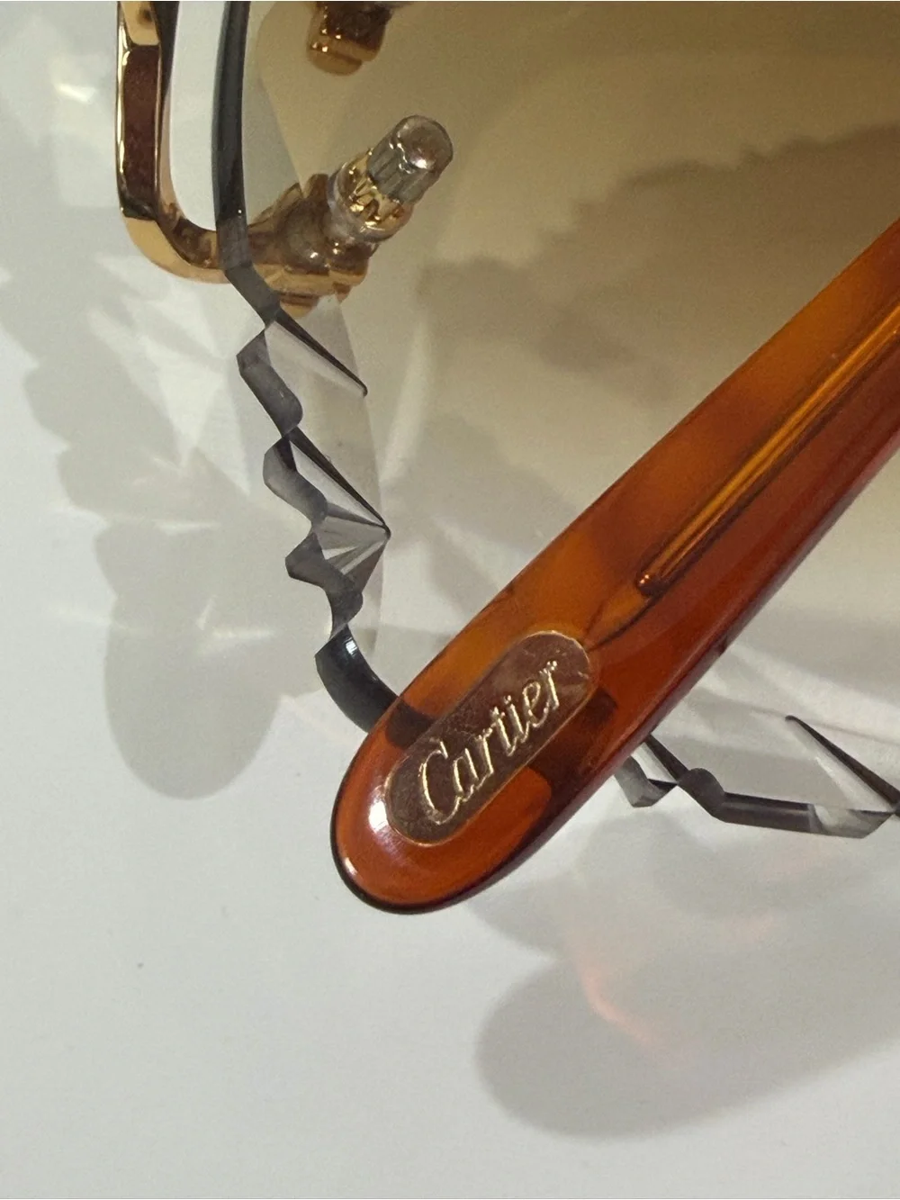 Cartier Men's Rimless Sunglasses with Purple Lenses and Gold Bridge